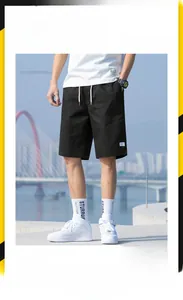 Detail of black cotton drawstring shorts with loose fit cut and functional side pockets