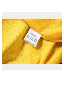 Close-up of men's yellow lightweight jacket showing 100% polyester breathable mesh fabric