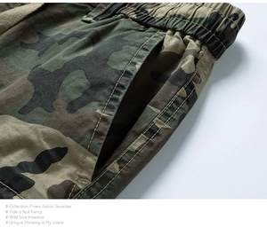 Macro shot of forest camouflage cargo shorts featuring elastic waist and reinforced side pocket