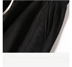Detailed close-up showing the side pocket design and texture of black suede shorts