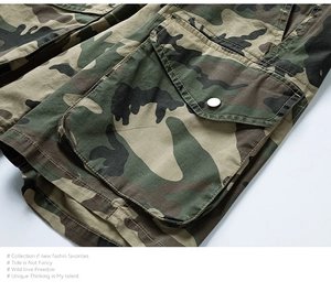 Detail of forest camouflage cargo shorts featuring heavy cotton fabric and a large buttoned pocket