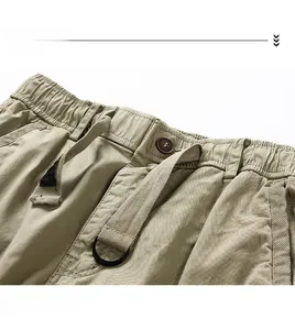 Detailed close-up of khaki utility shorts featuring elastic waistband and drawstring detail