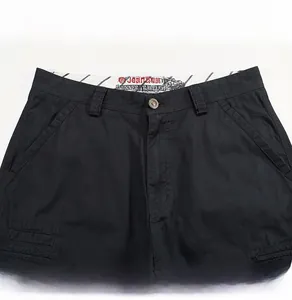 Close-up of black cotton cargo shorts waistband with metal button and inner print details