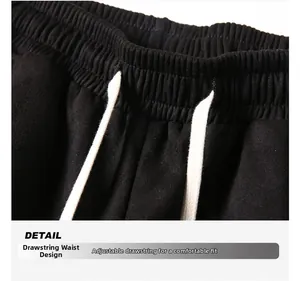 Detailed macro view of men's suede shorts featuring elastic waistband and cotton drawstring