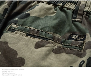 Detail of camouflage cargo shorts featuring elastic waist and premium woven brand label