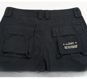 Detail view of cotton cargo shorts back featuring dual flap pockets and letter printing