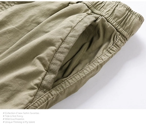 Macro detail of khaki cargo shorts showing elastic waistband and twill cotton fabric