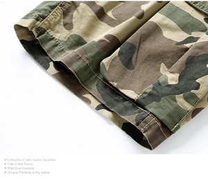 Close-up of forest camouflage twill fabric with detailed stitching on cargo shorts