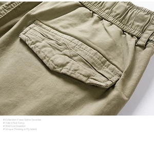 Detail of khaki cargo shorts showing elastic waistband and reinforced back flap pocket