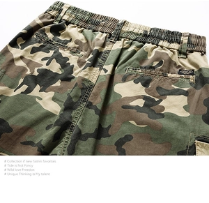 Detailed macro view of camo cargo shorts featuring elastic waistband and rear pocket design