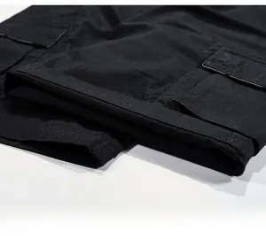 Detail of black cotton cargo shorts showing heavy-duty leg opening and side pocket