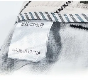 Close-up of wash label on cargo shorts showing 100% cotton fabric and care instructions