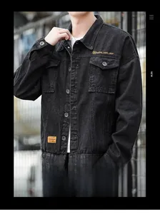 Detail of black denim utility jacket with metal buttons and yellow brand patch on pocket