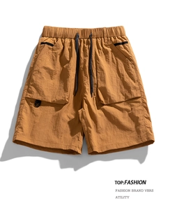 Close-up of khaki cargo shorts with elastic drawstring waist and tactical side pocket detail