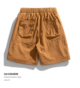 Detailed back view of caramel cargo shorts featuring elastic waist and rear patch pockets