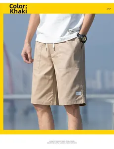 Outdoor shot of men's khaki cotton cargo shorts with a drawstring elastic waist detail