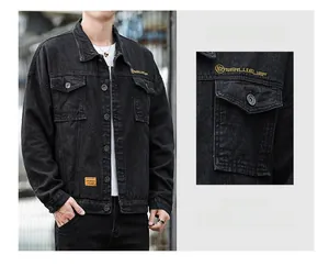 Detail view of black denim jacket featuring yellow embroidery and classic metal buttons
