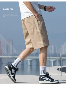 Close-up of khaki cotton cargo shorts featuring a side pocket and relaxed urban streetwear style