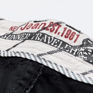 Men's loose black cotton cargo shorts featuring a vintage printed inner waistband lining