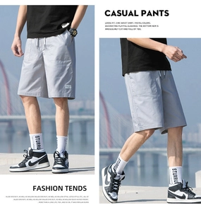 Detail showing elastic drawstring waistband and light gray breathable fabric of men's casual shorts