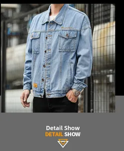 Detail view of light blue denim jacket with embroidered gold text and chest pocket