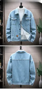 Detail of light blue denim jacket with thick white sherpa lining and fashion leather patch