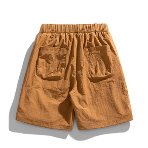 Loose fit quick-dry cargo shorts in mustard brown with elastic waist and large back pockets