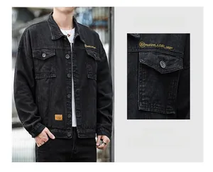 Close-up of black denim jacket with yellow logo embroidery and metal buttons