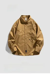 Detailed flat lay of khaki workwear shirt featuring asymmetric double pockets and canvas texture