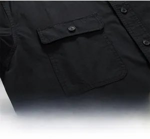 Detail of black cotton shirt featuring a chest pocket with white 91.S.SHEAR printed text