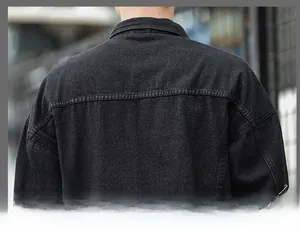 Detail of washed black denim jacket showing stitching and seam work on the back