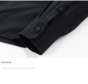 Detail of a black long-sleeve shirt cuff featuring a single-button rounded corner design