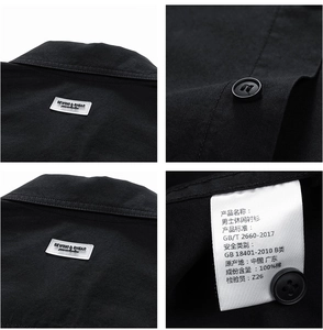 Detail view of black cotton shirt collar, buttons, labels and washing instructions