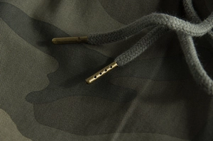 Detail view of cotton camo fabric with durable metal tips and woven drawstring cord