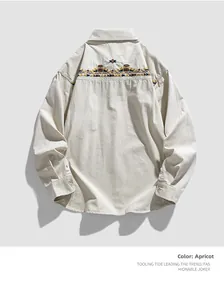Detail view of ethnic geometric embroidery on the back of the apricot long-sleeve shirt