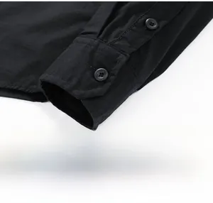 Macro shot of black long-sleeve shirt cuffs with double-button details and twill texture
