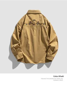 Detailed view of the vintage ethnic embroidery on the back of this khaki long sleeve shirt