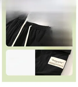 Detail of men's cargo shorts featuring elastic drawstring waist and white fabric patch