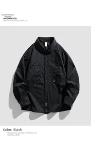 Detail of a black long-sleeve utility shirt with chest pockets and button-down front