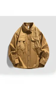 Detail view of khaki workwear shirt featuring symmetrical chest flap pockets and cotton fabric