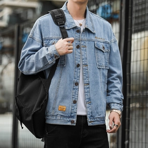 Men's light blue washed denim jacket with chest pockets and fashion labels