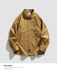 Detail view of khaki long sleeve work shirt with front utility pockets and buttons