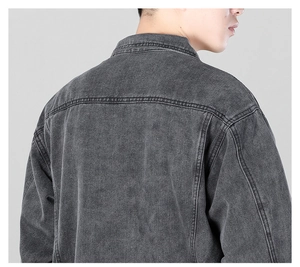 Detail view of the back seams and washed denim texture of a slim fit men jacket