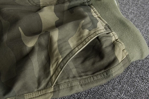 Detail view of cotton camo shorts showing reinforced side pockets and ribbed waist texture