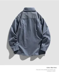 Detail of blue-gray long-sleeved work shirt showing back pleats and fabric texture