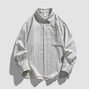 Vertical striped long-sleeved button-up shirt with front pocket on light grey background