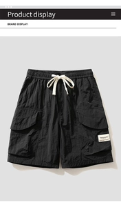 Detail of black cargo shorts featuring drawstring waist and Antarctic brand label
