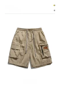 Detail of khaki cargo shorts showing elastic drawstring waist and street sports pocket