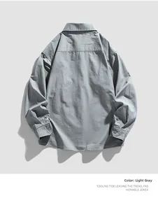 Detail view of light grey workwear shirt featuring fine vertical texture and back yoke seams