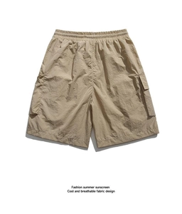 Detail of khaki cargo shorts showing elastic waistband and large side pockets